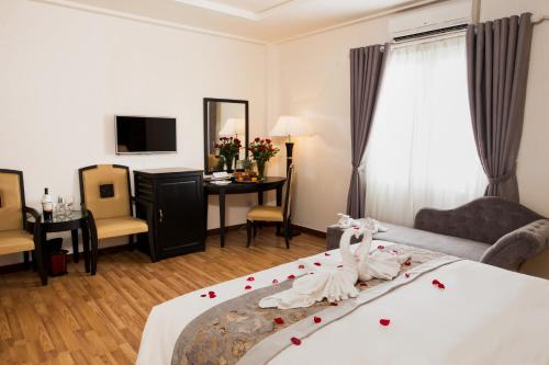 Postel nebo postele na pokoji v ubytování Rosaleen Boutique Hotel