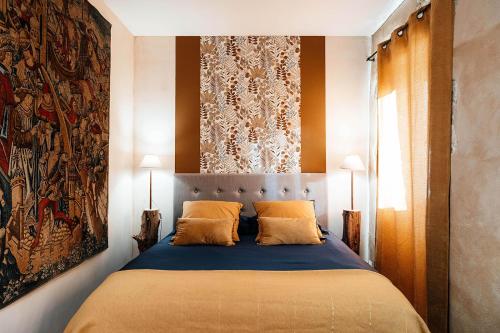 a bedroom with a bed with two pillows at LA MOTTE FÉODALE luxury medieval MANOR rated 5 stars in Normandy in Le Mesnil-Jourdain
