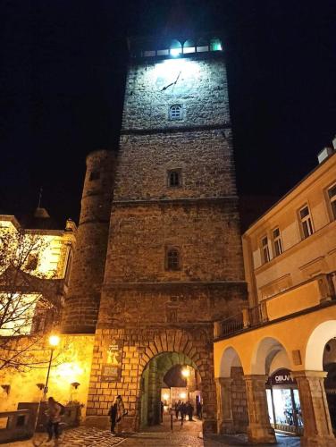 a large tower with a clock on top of a building at Chaty v Českém ráji u Prachovských skal - Malá chata pro 4 - Velká chata pro až 7 osob - ubytování v soukromí in Jičín