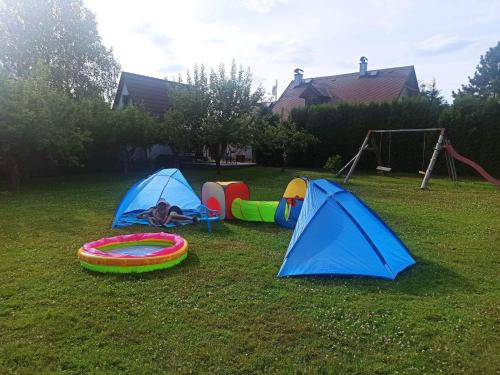 a group of tents on the grass in a yard at Chaty v Českém ráji u Prachovských skal Chata pro 4 a pro až 7 osob - v soukromí in Holín
