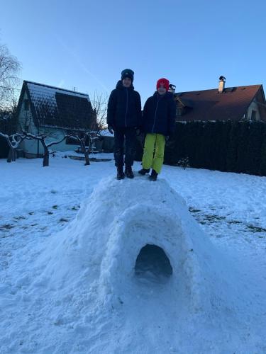 two people standing on top of a pile of snow at Chaty v Českém ráji u Prachovských skal - Malá chata pro 4 - Velká chata pro až 7 osob - ubytování v soukromí in Jičín
