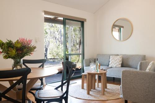 a living room with a couch and a table at Island Brook Estate Vineyard and Chalets in Yelverton