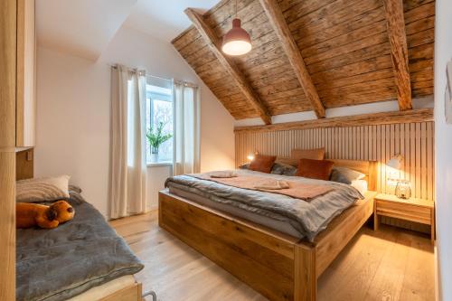 a bedroom with two beds and a large window at Wellness Apartmány Vila Republika in Velké Losiny