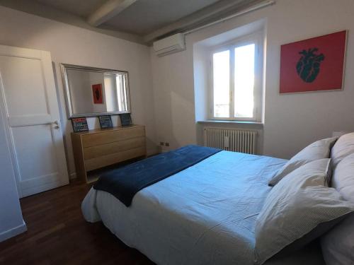 a bedroom with a large bed and a window at Mount Flower Trastevere Apt in Rome