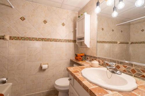 een badkamer met een wastafel en een toilet bij Au p'tit cocon sur le lac in Magog-Orford