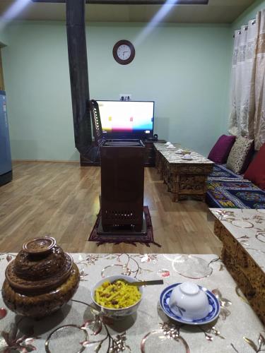 a living room with a table with bowls of food at Nakpo Homestay in Leh