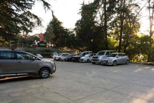 a row of cars parked in a parking lot at Country Inn Nature Resort Bhimtal in Bhīm Tāl