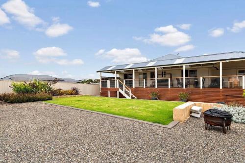 a house with a lawn in front of it at The Beach House in Middleton