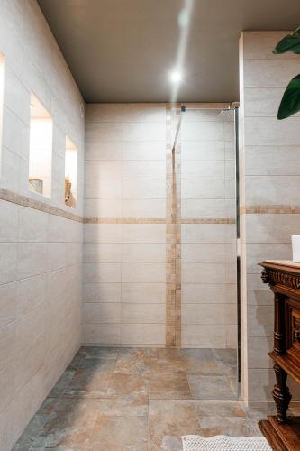 a bathroom with a shower with a glass door at LA MOTTE FÉODALE luxury medieval MANOR rated 5 stars in Normandy in Le Mesnil-Jourdain