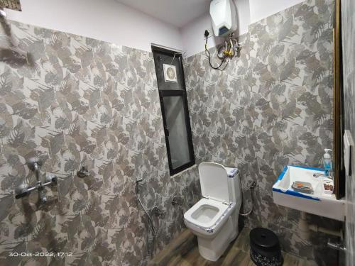 ein Bad mit einem WC und einem Waschbecken in der Unterkunft OSHO Villa Guest House in Jaipur