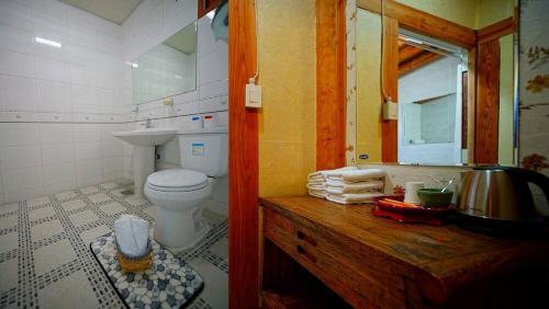 a bathroom with a toilet and a sink at Kumwondang Jeonju Hanokstay in Jeonju