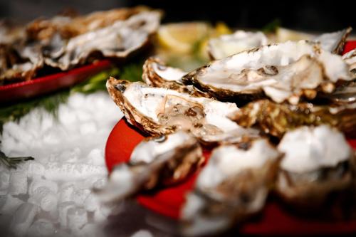 a pile of oysters sitting on a red plate at Palazzo Ignazio in Valletta
