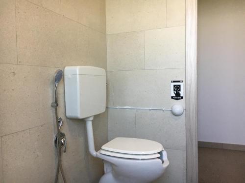 a bathroom with a white toilet in a stall at Agriturismo Crilù in Milazzo