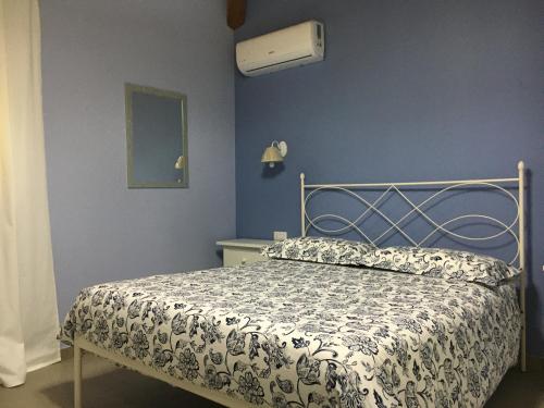 a bedroom with a bed with a white comforter at Agriturismo Crilù in Milazzo