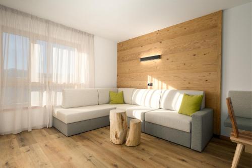 a living room with a white couch and a window at Neuhuberhof in Vols am Schlern
