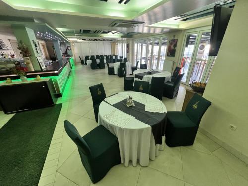 a dining room with tables and chairs in a restaurant at Hotel Staccato in Prijedor