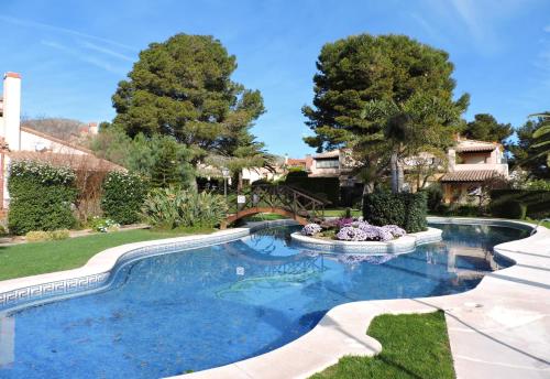 a swimming pool with a fountain in a yard at Doree 449 in Bonmont Terres Noves