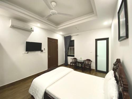 a bedroom with a bed and a tv on the wall at Tien Minh Hotel 113 Le Thanh Nghi in Hanoi