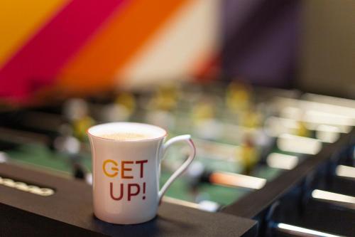 a cup of coffee sitting on a table at Ginger Chandigarh, Zirakpur in Zirakpur