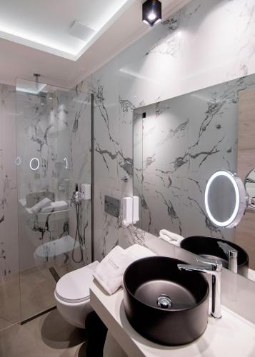 a bathroom with a sink and a toilet at Chrousso Village in Paliouri