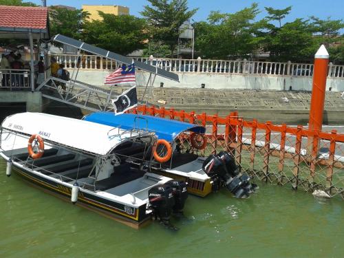 a boat is tied to a dock in the water at IZ Budget in Kuala Besut