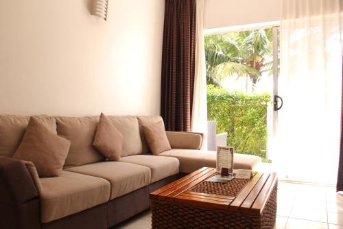a living room with a couch and a coffee table at The Melanesian Port Vila in Port Vila
