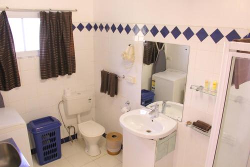 a small bathroom with a toilet and a sink at The Melanesian Port Vila in Port Vila