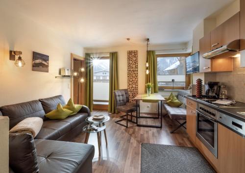 a kitchen and living room with a couch and a table at Appartements Fortuna in Pertisau