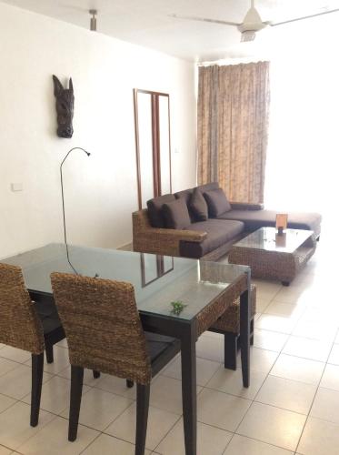 a living room with a couch and a table and chairs at The Melanesian Port Vila in Port Vila