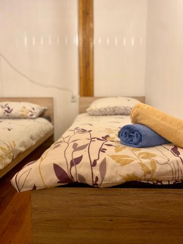 a bedroom with two beds with towels on it at Ruralna kuća za odmor Klet Karas in Kozarevac