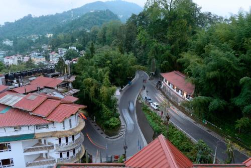 a view of a street in a town with trees at Yashshree Sikkim Blossom 600 Meters from MG Marg in Gangtok