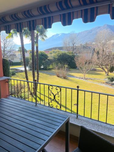 a balcony with a view of a field and mountains at Mon Bijoux in Ascona