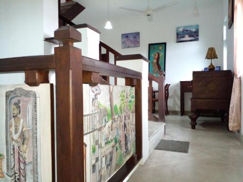 a room with a cross and pictures on the wall at Muduna Walawwa Resort in Kandy