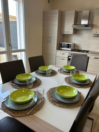 a kitchen with a table with green dishes on it at Residenza del Parco in Quartucciu