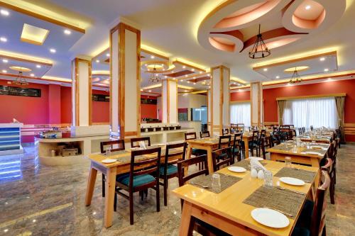 a dining room with wooden tables and chairs at Yashshree Sikkim Blossom 600 Meters from MG Marg in Gangtok
