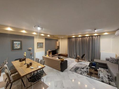 a living room with a couch and a table at central luxury apartment in Volos