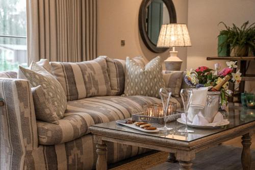 a living room with a couch and a table with candles at Marlfield House Hotel in Gorey