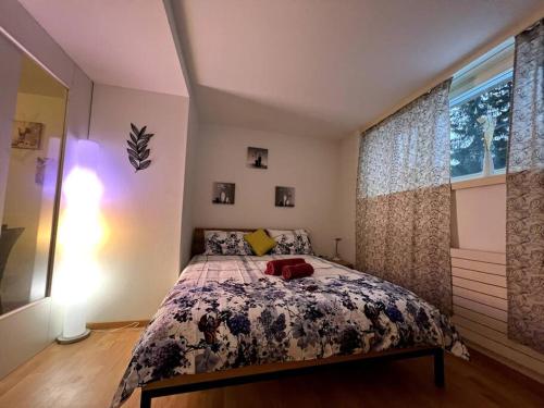 a bedroom with a bed with a floral bedspread at Lovely 2 Bedrooms Apartment in Davos Platz, Davos in Davos