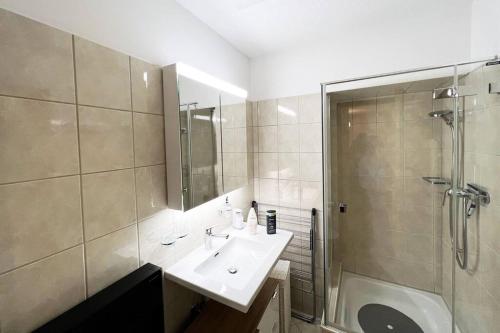 a bathroom with a sink and a shower at Lovely 2 Bedrooms Apartment in Davos Platz, Davos in Davos