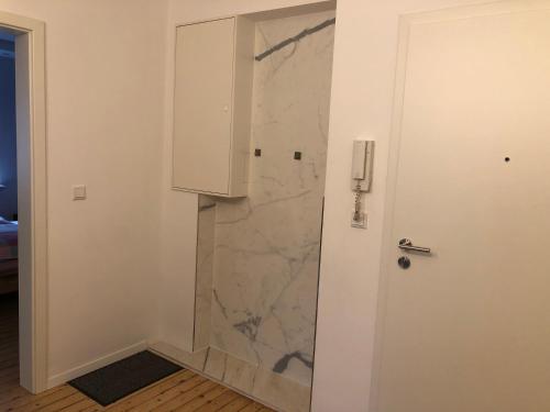a bathroom with a marble shower with a door at Zentrale Unterkunft in Dortmund City in Dortmund