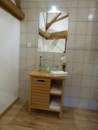 a bathroom with a sink and a mirror at Logis de L'Arceau in Celles