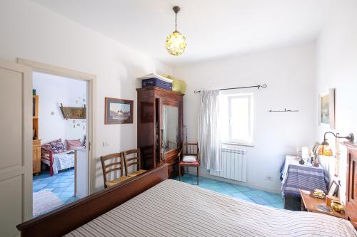 a bedroom with a bed and a living room at La rosa dei venti in Procida