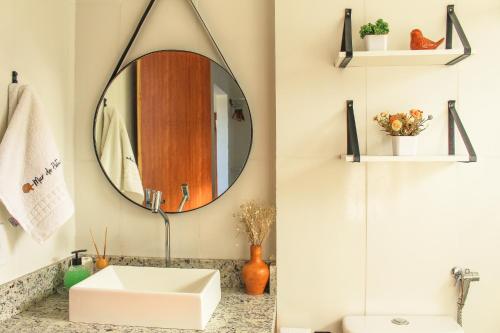 a bathroom with a sink and a mirror at Casa Mar do Patacho in Pôrto de Pedras