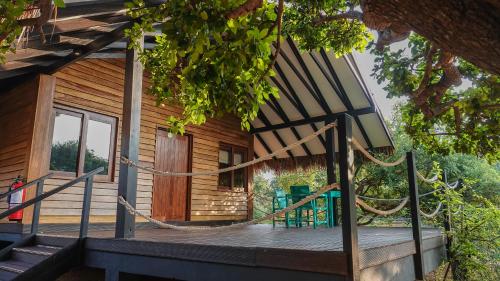 a porch of a house with a hammock on it at Jetwing Safari Camp in Yala