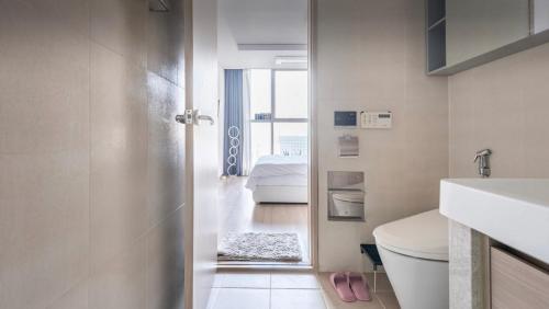 a bathroom with a door leading to a bedroom at Urban Exit Studio Gangnam in Seoul