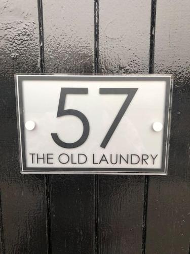 a sign for the old laundry on a wall at The Old Laundry in Rye