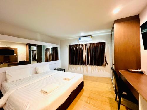 um quarto com uma cama grande e lençóis brancos em Bed By Cruise Hotel At Samakkhi-Tivanont em Nonthaburi