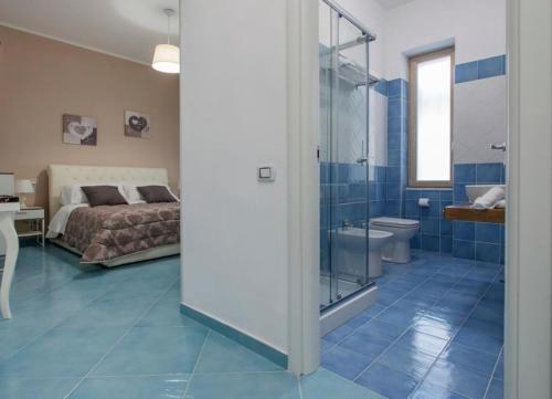 a bedroom with a bed and a bathroom with a shower at Ad Maiora in Salerno