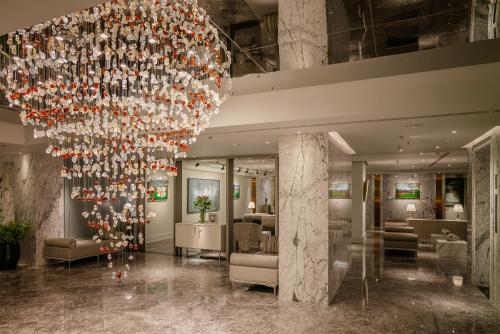 a large chandelier in the lobby of a hotel at Le Jardin Hotel Haute Couture in Hanoi