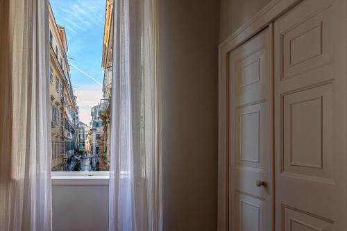 a window with a view of a city at Dal Dottore II in Corfu Town